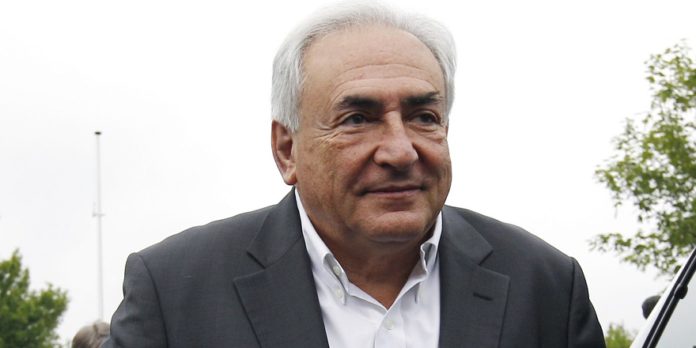 Former IMF head Dominique Strauss-Kahn arrives at a polling station in the second round of the 2012 French presidential elections in Sarcelles