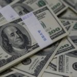 U.S. one-hundred dollar bills are seen in this photo illustration at a bank in Seoul
