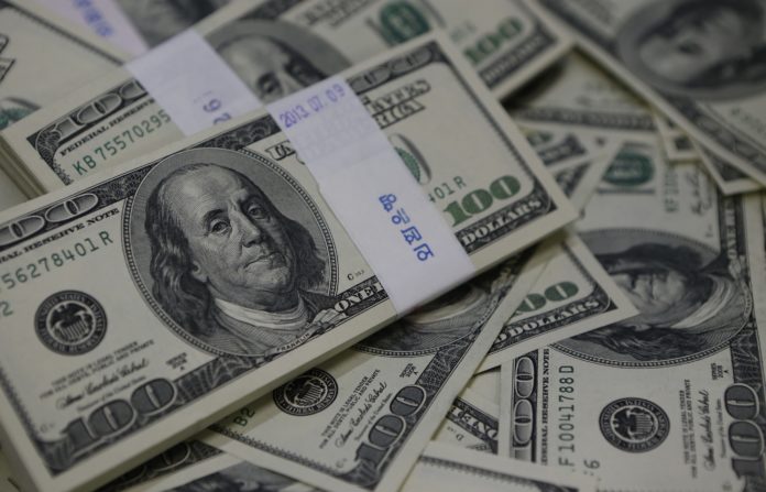 U.S. one-hundred dollar bills are seen in this photo illustration at a bank in Seoul